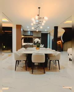 a dining room with a white table and chairs at House Of Sea Breeze in Uluwatu