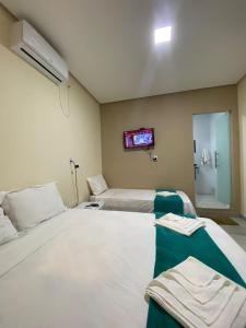 Cama ou camas em um quarto em Pousada Vista da Serra - Suzart