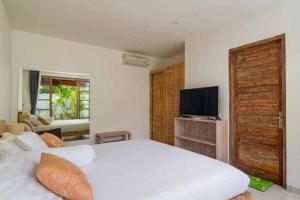 Ένα ή περισσότερα κρεβάτια σε δωμάτιο στο Villa Catta Seminyak