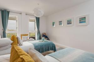 a bedroom with two beds and a window at Host & Stay - Sunset in Newquay