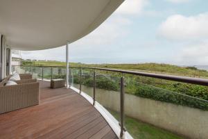 a balcony of a house with a view of the ocean at Host & Stay - Sunset in Newquay