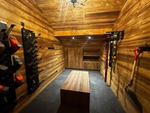 a room with wooden walls and a room with skis at Nouveau ! Chalet pied des pistes in Champagny-en-Vanoise
