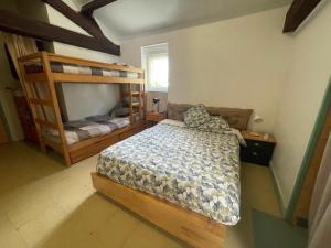a bedroom with two bunk beds in a room at chambre 4 personnes avec entrée indépendante , grand parking, salle de bain, wc in Confolens