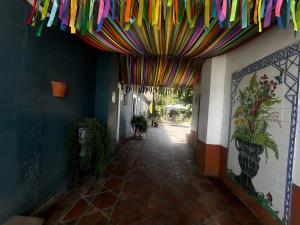 a hallway with colorful flags hanging from a building at Hotel Olimpia Centro Histórico in Monclova +40 photos