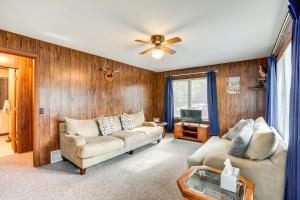 a living room with two couches and a tv at Cabin in Boulder Junction with Fire Pit and Deck! in Boulder Junction