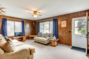 a living room with a couch and a tv at Cabin in Boulder Junction with Fire Pit and Deck! in Boulder Junction