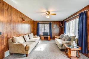 a living room with two couches and a tv at Cabin in Boulder Junction with Fire Pit and Deck! in Boulder Junction