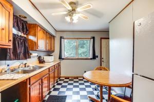 a kitchen with a table and a ceiling fan at Cabin in Boulder Junction with Fire Pit and Deck! in Boulder Junction