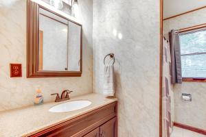 a bathroom with a sink and a mirror at Cabin in Boulder Junction with Fire Pit and Deck! in Boulder Junction