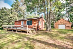 a log cabin with a porch and a shed at Cabin in Boulder Junction with Fire Pit and Deck! in Boulder Junction