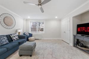 a living room with a blue couch and a tv at Luxury on a Budget, Centrally Located Gem in Atlanta