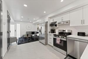 a kitchen with a stove and a living room at Luxury 171-7 Condos with Magnificent Lakeviews in Leamington
