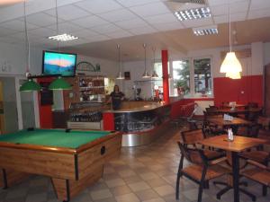 a restaurant with a pool table and a bar at Zajazd Markowski in Bojanowo