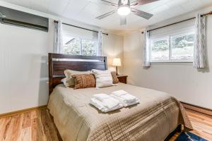 a bedroom with a bed with two towels on it at 6 Mi to Waterrock Knob Serenity Cottage in Maggie Valley