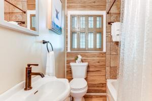 a bathroom with a toilet and a sink and a tub at 6 Mi to Waterrock Knob Serenity Cottage in Maggie Valley +22 photos