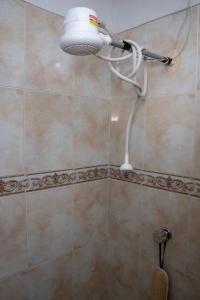 a shower with a shower head in a bathroom at Lala's House Fusagasugá in Fusagasuga