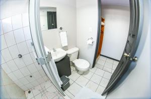 a small bathroom with a toilet and a sink at Hotel La Vid La Fortuna in Fortuna +30 photos