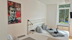a bedroom with a bed with two swans on it at City Central Apartment House in Kaiserslautern