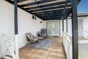 a pergola with chairs and a desk on a patio at Updated 3-Bedroom LA Home with Backyard, BBQ & Family-Friendly Amenities in Los Angeles