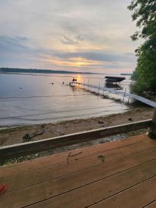 een steiger aan een meer met de zon die in het water ondergaat bij Family Shoreline Hideaway in Ortonville +32 foto's