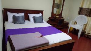 Кровать или кровати в номере Haranya Homestay