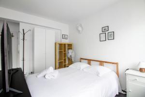 a bedroom with a bed with white sheets and pillows at Sweet-Neipperg in Luxembourg