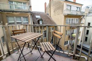 a balcony with two chairs and a table on a balcony at Sweet-Neipperg in Luxembourg