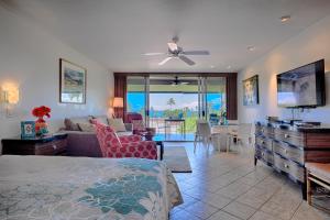 a bedroom with a bed and a living room at Maui Eldorado Condo K206 in Kaanapali