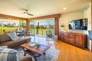 a living room with a couch and a tv and a table at Maui Eldorado Condo G206 in Kaanapali