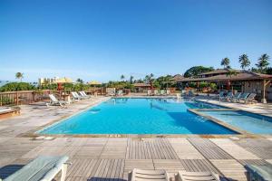 a large swimming pool with lounge chairs in a resort at Maui Eldorado Condo G206 in Kaanapali