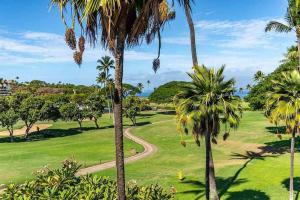 a park with palm trees and a path at Maui Eldorado Condo G206 in Kaanapali