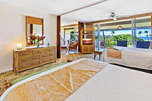 a hotel room with two beds and a mirror at Maui Eldorado Condo F203 in Kaanapali +37 photos