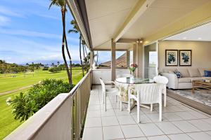 a balcony with a table and chairs and a couch at Maui Eldorado Condo A206 in Kaanapali