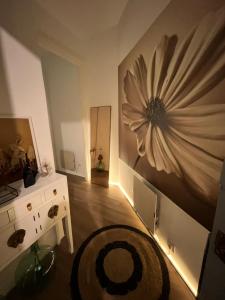 a room with a desk and a flower painting on the wall at House Pajarillo in Vigo