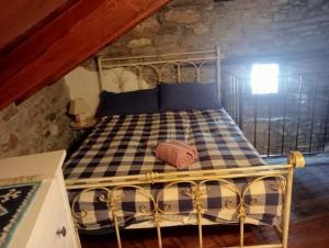 a bedroom with a metal bed in a attic at Home Sweet Home in Antey-Saint-André