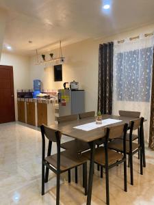 a dining room table and chairs in a kitchen at ChemRald Guesthouse in Santander