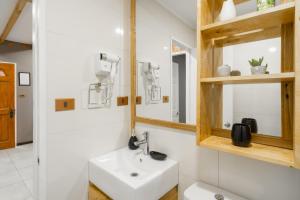 a bathroom with a sink and a mirror at Pucón Rec-Lodge Cabaña Carpintero in Pucón +34 photos