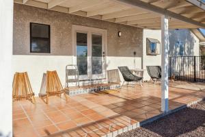 a patio with chairs and a table on a house at Lazy H Bar Desert Outpost Ranch House with Pool and Hot Tub in Tucson