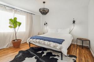 a bedroom with a bed and a potted plant at Lazy H Bar Desert Outpost Ranch House with Pool and Hot Tub in Tucson