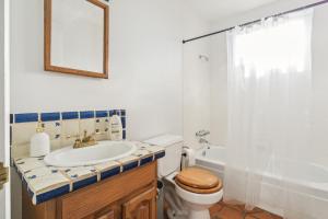 a bathroom with a sink and a toilet and a shower at Lazy H Bar Desert Outpost Ranch House with Pool and Hot Tub in Tucson