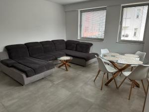 a living room with a couch and a table at 2-izbový apartmán VALMAR v centre Piešťan in Piešťany