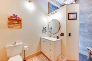 a bathroom with a toilet and a mirror at Fire Pit and Views Pet-Friendly Vermont Cabin in Craftsbury +29 photos