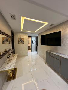 a large living room with a flat screen tv on the wall at اقامة لوكس in Nador