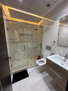 a bathroom with a shower and a toilet and a sink at اقامة نور in Nador