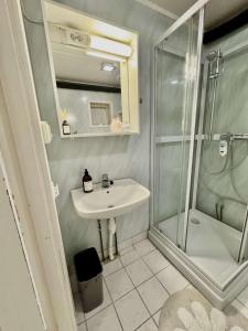 a bathroom with a sink and a shower at Aurora Stay- Aurora garden Apartment in Tromsø