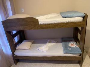 two bunk beds with towels and a pair of shoes on them at Pousada Ohana Rj in Rio de Janeiro