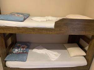 two bunk beds in a room with towels on them at Pousada Ohana Rj in Rio de Janeiro