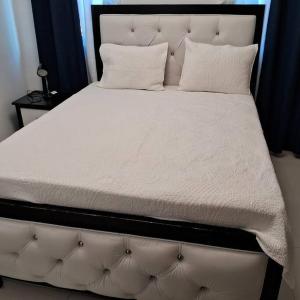 a large white bed with two pillows on it at Pool Sensation Punta Cana in Bávaro +59 photos