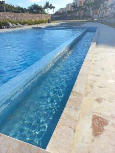 a large swimming pool with blue water at Pool Sensation Punta Cana in Bávaro