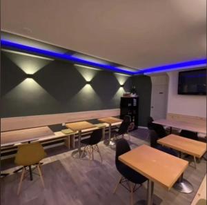 a classroom with tables and chairs and blue lights at Hostal Oliveta Budget in Barcelona